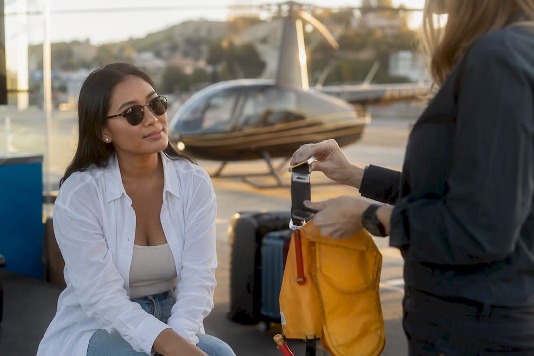 Passenger receiving helicopter tour safety briefing