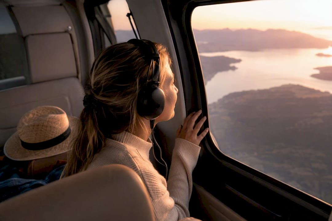 Passenger gazing at horizon through helicopter window