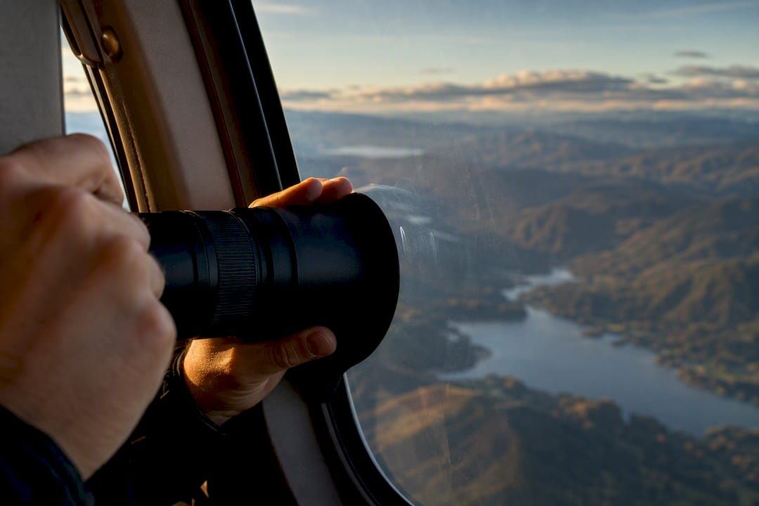 Lens hood pressed against helicopter window