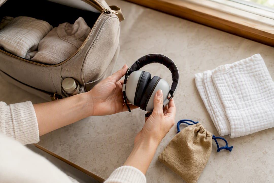 Infant hearing protectors beside diaper bag