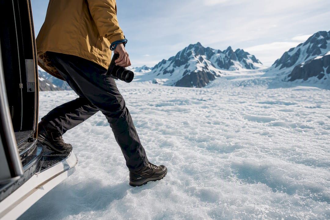 Traveler stepping onto an Alaskan glacier